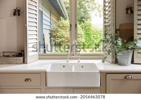 Domestic kitchen with clean sink and countertop Royalty-Free Stock Photo #2056463078