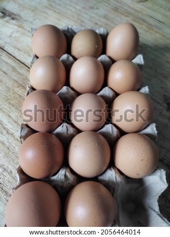 photo of chicken eggs on a wooden background