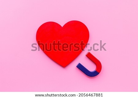 Love and relashionship concept. Horseshoe magnet with heart shapes