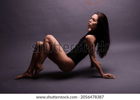 Happy beautiful girl dancing and standing in full length, isolated on studio background