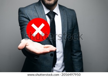 man holding a rejection icon in his hand