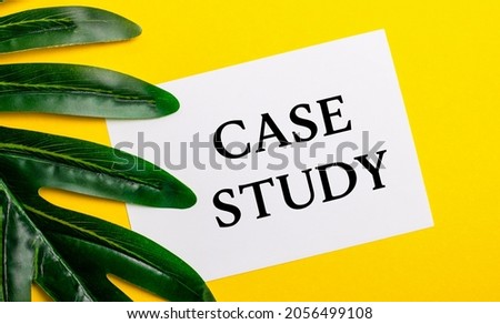 White sheet of paper with the inscription CASE STUDY on a bright yellow background near the green leaf of the plant. Eco natural banner concept