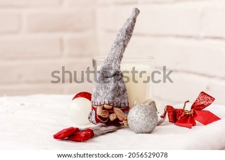 Christmas decoration with Scandinavian traditional gnome Tomte, Nisse, white candle, and Christmas balls on white background