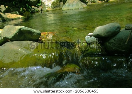 Photo of a clear river and beautiful rocks