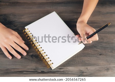 woman making notes in a notebook