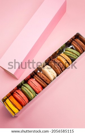 delicious macaroons on pastel color background