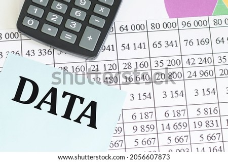 Text DATA on blue paper for notes on the background of the tabalter reporting next to the calculator