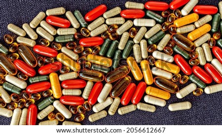 multivitamin supplement pills, capsules and softgels close-up. dietary supplement capsules on burlap rag. immune support medical concept top view Royalty-Free Stock Photo #2056612667