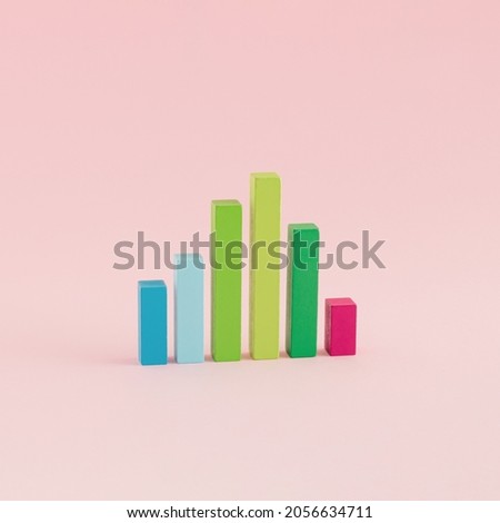 A creative arrangement of statistical data representation made of wooden cuboids on a pink background. Minimal data or development concept. Statistics, analysis and diagram Inspiration. Royalty-Free Stock Photo #2056634711