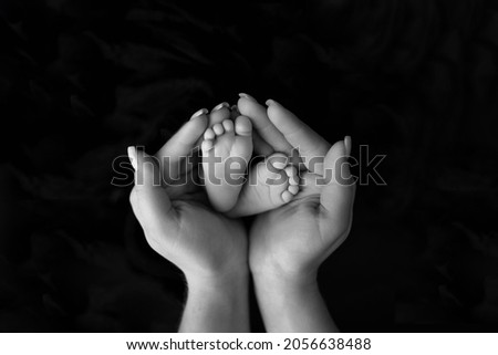 childish feet on a black background