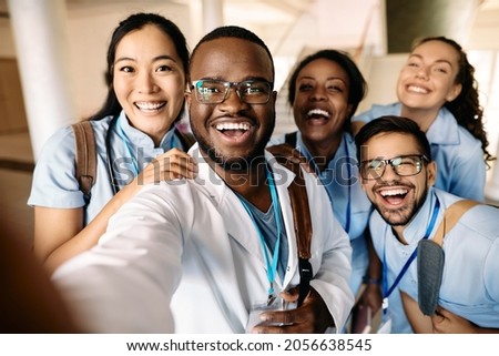 Multi-ethnic group of happy students having fun wile taking selfie at medical university. Royalty-Free Stock Photo #2056638545