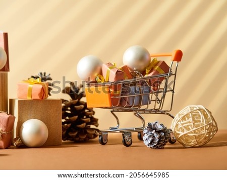 Shopping, online shopping, New Year and Christmas discounts, sales, Black Friday. Shopping cart, Christmas balls and cones. New Year and Christmas decor. There are no people in the photo.