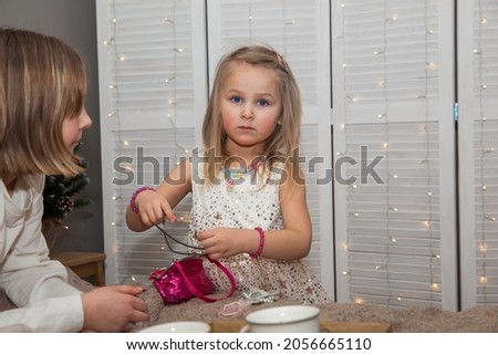 Cute children of girls in festive clothes dress up before Christmas, New Year's concept