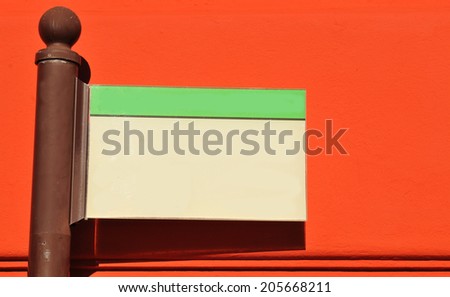  Blank direction indicator isolated against red wall