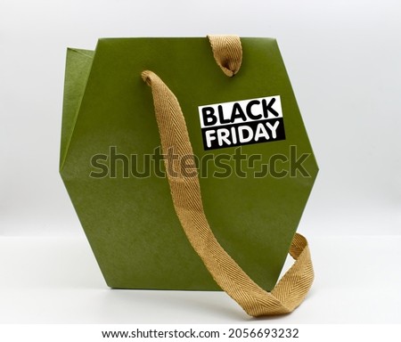 Green paper bag with Black Friday logotype. Black Friday concept