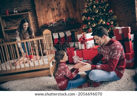 Photo of noel celebration concept people enjoy play game wear sweater in decorated x-mas home indoors