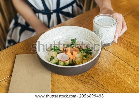 Okroshka with kefir on a wooden table