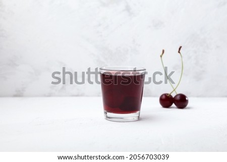 Ginjinha or Ginja - Portuguese liqueur made by infusing ginja berries (sour cherry, Prunus cerasus austera, Morello cherry) in alcohol (aguardente) and adding sugar. Royalty-Free Stock Photo #2056703039