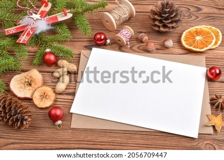 Christmas background with an envelope, toys and eco-decorations. Natural design of the New Year's holiday. A place to copy. Flat position, top view.