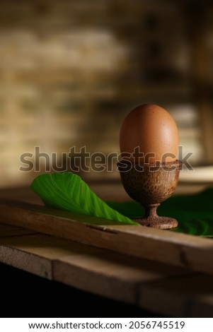 Free-range chicken eggs in minimalist teak wood cup containers