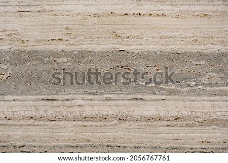 A grey and cream combination of horizontal line-based marble texture.