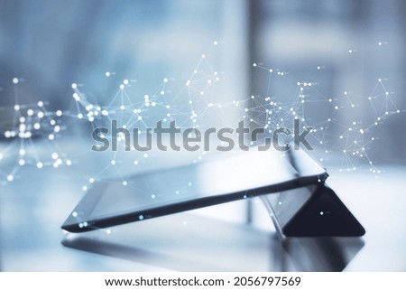 Close up of tablet at desktop with glowing polygonal mesh on blurry background. Technology, network and connections concept. Double exposure