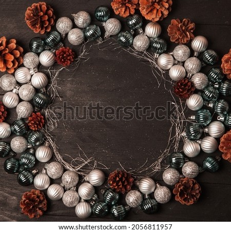 Christmas frame background with copyspace. Merry Christmas and Happy New Year banner with tree balls and pine cones.