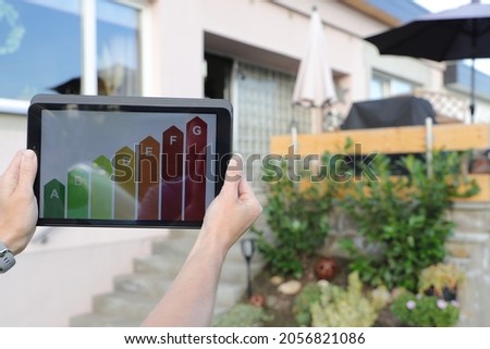 Energy label on a tablet with a house in the background Royalty-Free Stock Photo #2056821086