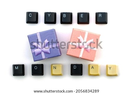The phrase cyber Monday is laid out from the keys of a computer keyboard, in the middle there are gift boxes on a white background. High quality photo