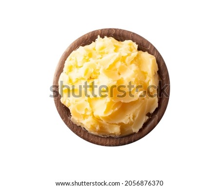 Ghee or clarified butter in wooden bowl, cooking oil, pure ghee isolated on white background. Clarified butter with copy space for text on white. Top view. Royalty-Free Stock Photo #2056876370