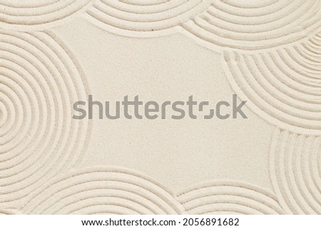 Lines drawing on sand, beautiful sandy texture. Spa background, concept for meditation and relaxation. Concentration and spirituality in Japanese zen garden. View from above.