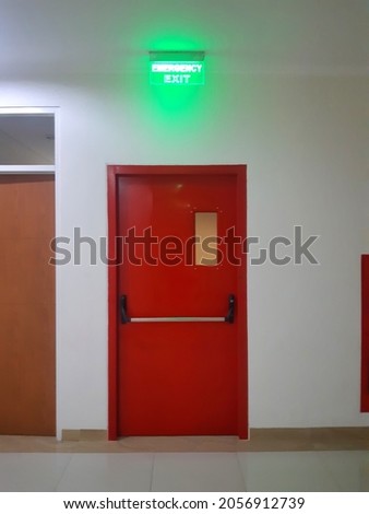 Red Door or Emergency Exit Door with Exit Sign for evacuation