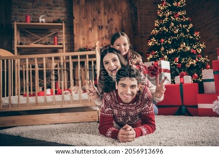 Photo of nice family mom dad daughter new born son show v-sign wear red sweater on christmas day in loft