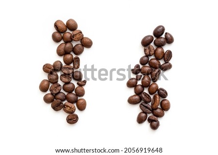 Two heaps of coffee grain Robusta and Arabica. Top view of roasted cofee beans robusta or Coffea Canephora and Arabica Royalty-Free Stock Photo #2056919648