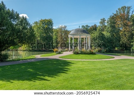 Circular temple, known as Temple of Love (early 19th century) in neoclassical style. Parc de l'Orangerie in Strasbourg. France, Europe. Royalty-Free Stock Photo #2056925474