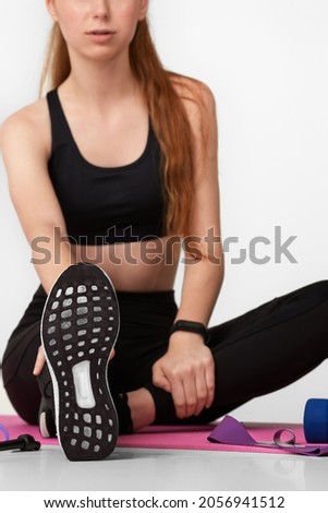 Strong sporty girl in black sportswear working out