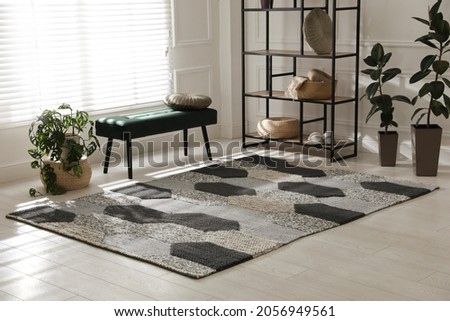 Stylish carpet with pattern on floor in room Royalty-Free Stock Photo #2056949561