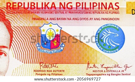 20 Piso banknote, Bank of Philippines, closeup bill fragment shows Coat of Arms, Bank emblem, signatures R. Duterte and N. Espenilla, issued 2010