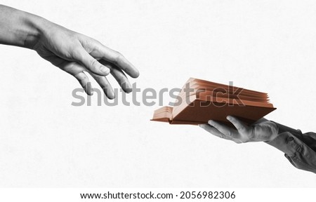 Two hands and open book. Learning, craving for new knowledge. Education concept. Black and white. Royalty-Free Stock Photo #2056982306