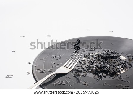 vintage vinyl music record looks like a plate with notes and cutlery on a white background