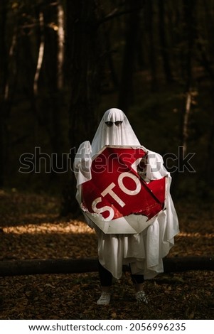 Ghost in the woods holding a stop sign.