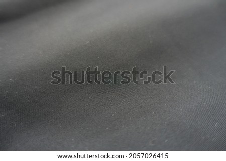 Closeup of simple thin black polyester fabric