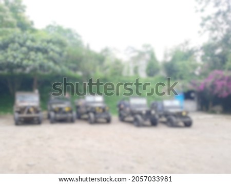 Defocused abstract background of a row of jeeps parked