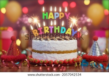 Birthday cake with text candles, sparklers and bright lights bokeh and balloons