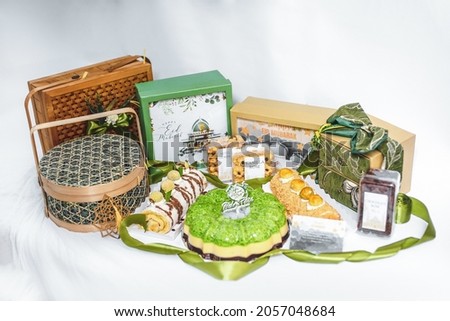 Ramadhan gift. Hampers moslem theme for celebrete the holy, can be bake snack, nastar, bakery, cookies, pudiing, chococips, roll cake, castangel, pandan. with greeting card and accsories. Royalty-Free Stock Photo #2057048684