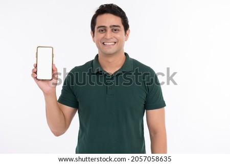 Attractive cheerful young man showing mobile phone. Royalty-Free Stock Photo #2057058635