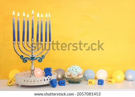 Religion image of jewish holiday Hanukkah background with menorah (traditional candelabra), doughnut and candles