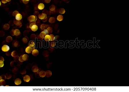 Bokeh circle with gold sparkles background. Yellow glitter backdrop. Monochrome Christmas texture. New year luxury snow. Copyspace. Shimmer confetti wallpaper. Dreamy shiny design detail. For multiply
