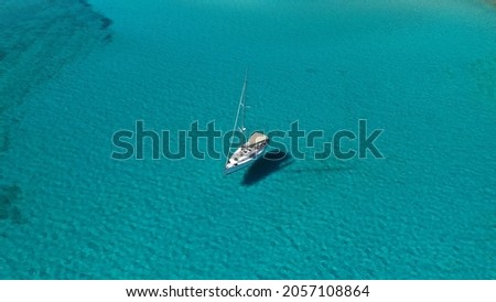 Aerial drone photo of luxury sail boat anchored in tropical exotic paradise bay with turquoise sea