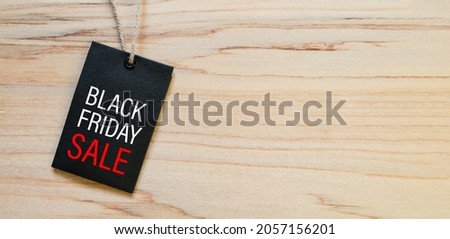 Top view of Black label (tag) with BLACK FRIDAY SALE text on wooded table background. Black friday sale concept. copy space for text